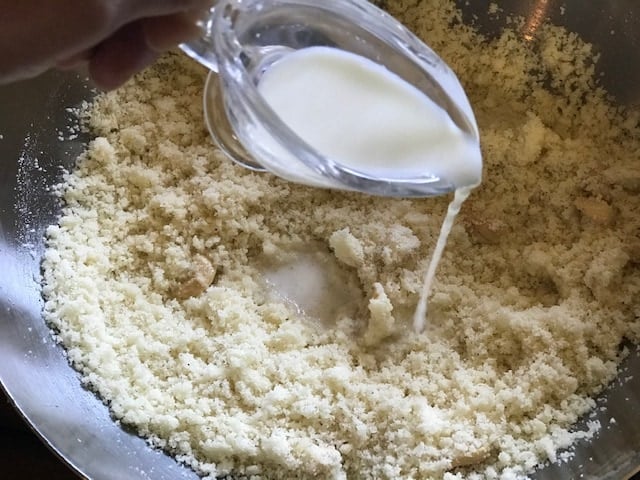 adding milk to make rava laddu