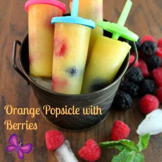 orange popsicle with berries and mint