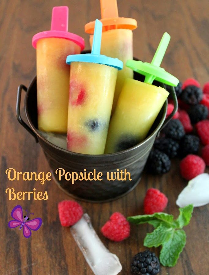 orange popsicle with berries and mint
