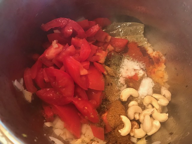 added tomato, cashew to onion mixture