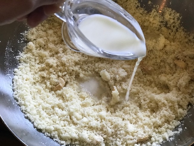 adding milk to make rava laddu