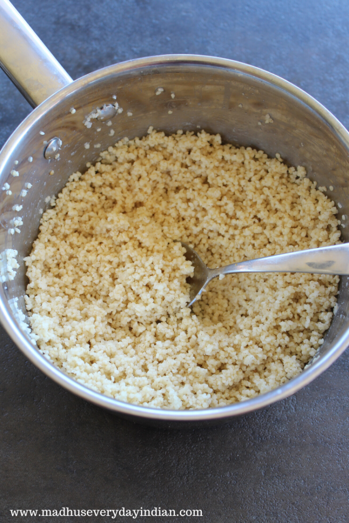 cooked millet in a steel sauce pot