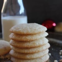stacked soft sugar cookies with a bottle of milk