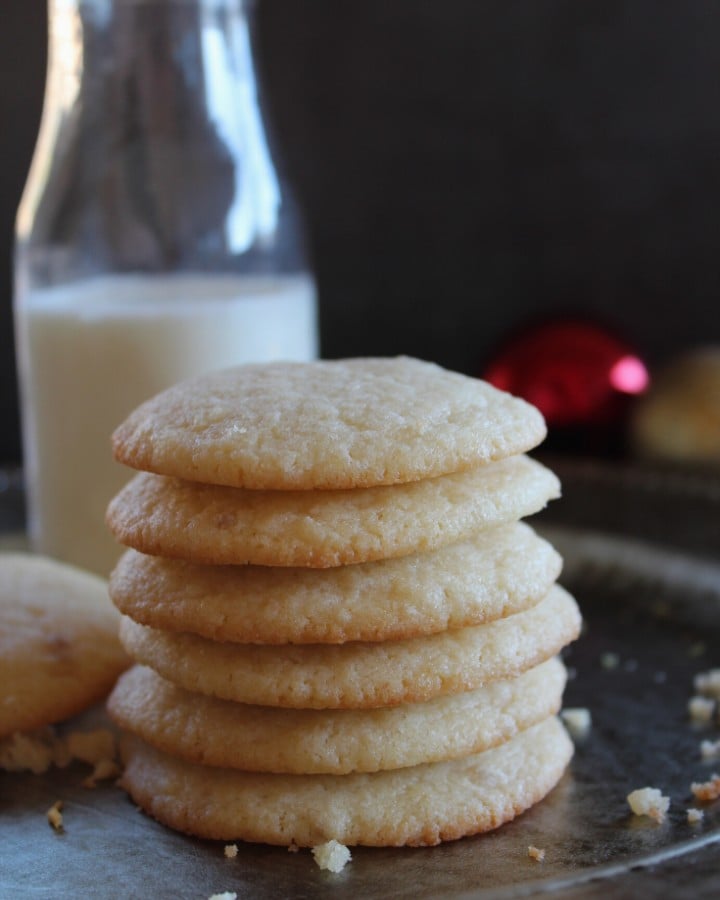 stacked soft sugar cookies with a bottle of milk