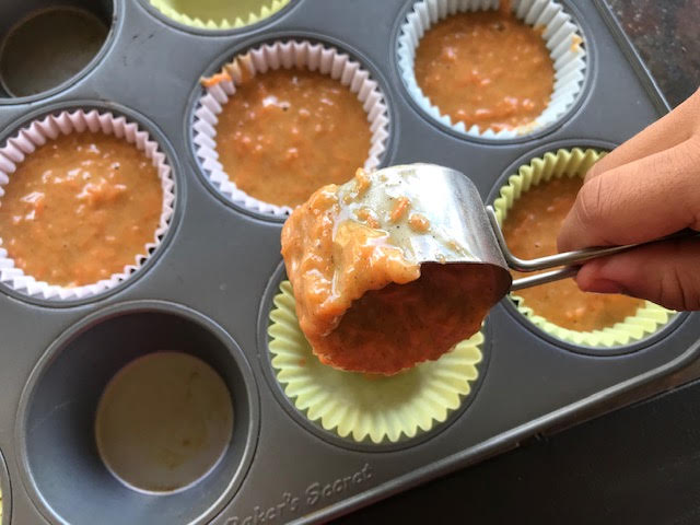 carrot cupcake batter scooped in to the muffin tin