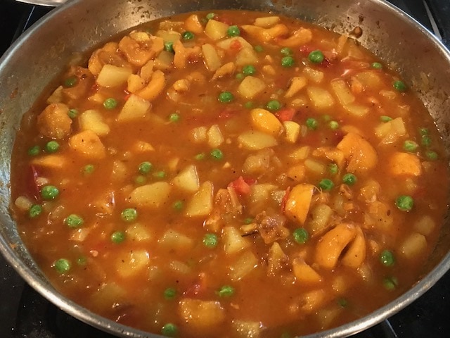 potato loquat curry cooking in a pan