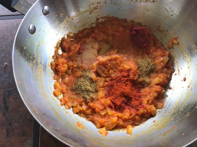 spices added to onion tomato mixture