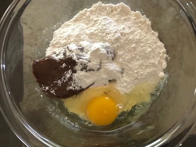 flour, nutella and egg added to a glass bowl