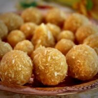 coconut jaggery ladoo served in a copper plate