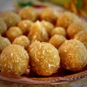 coconut jaggery ladoo served in a copper plate