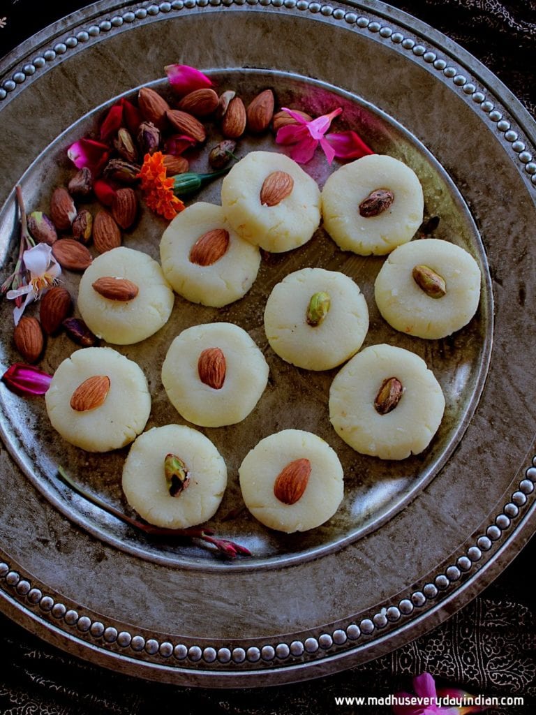 malai peda swerved ina plate with almonds and few flowers for garnish