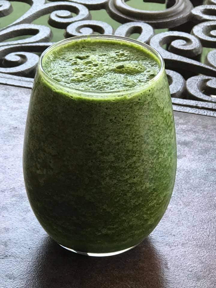 spinach smoothie served in a glass cup
