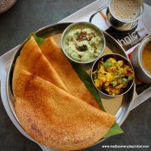 instant wheat dosa served in asteel plate with coconut chutney, potato fry, sambar and coffee