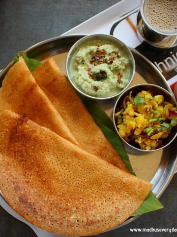 instant wheat dosa served in asteel plate with coconut chutney, potato fry, sambar and coffee