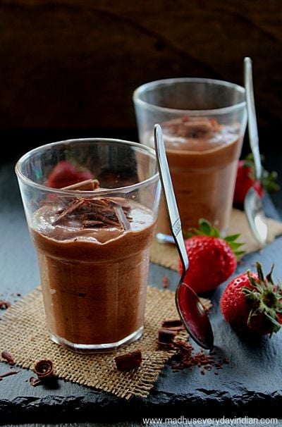 nutella mousse served in glass cups with chocolate shavings and strawberry and spoon