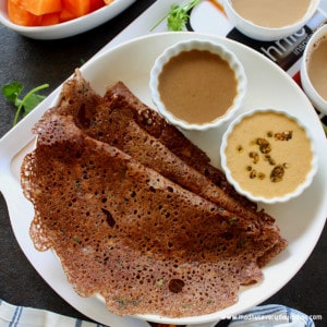 ragi dosa served in a white place with chutney and coffee