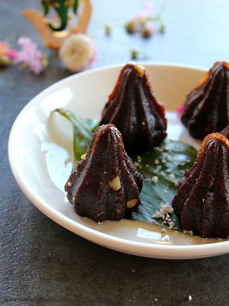 ragi modak arranged in a white plate and garnished with coconut