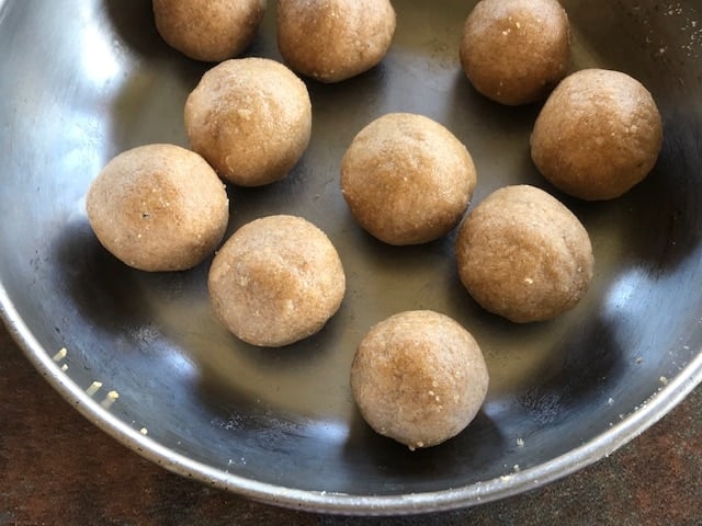 10 almond flout ladoo displaced in a steel pan