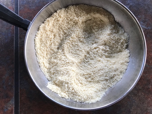 pan fried almond flour in a steel pan
