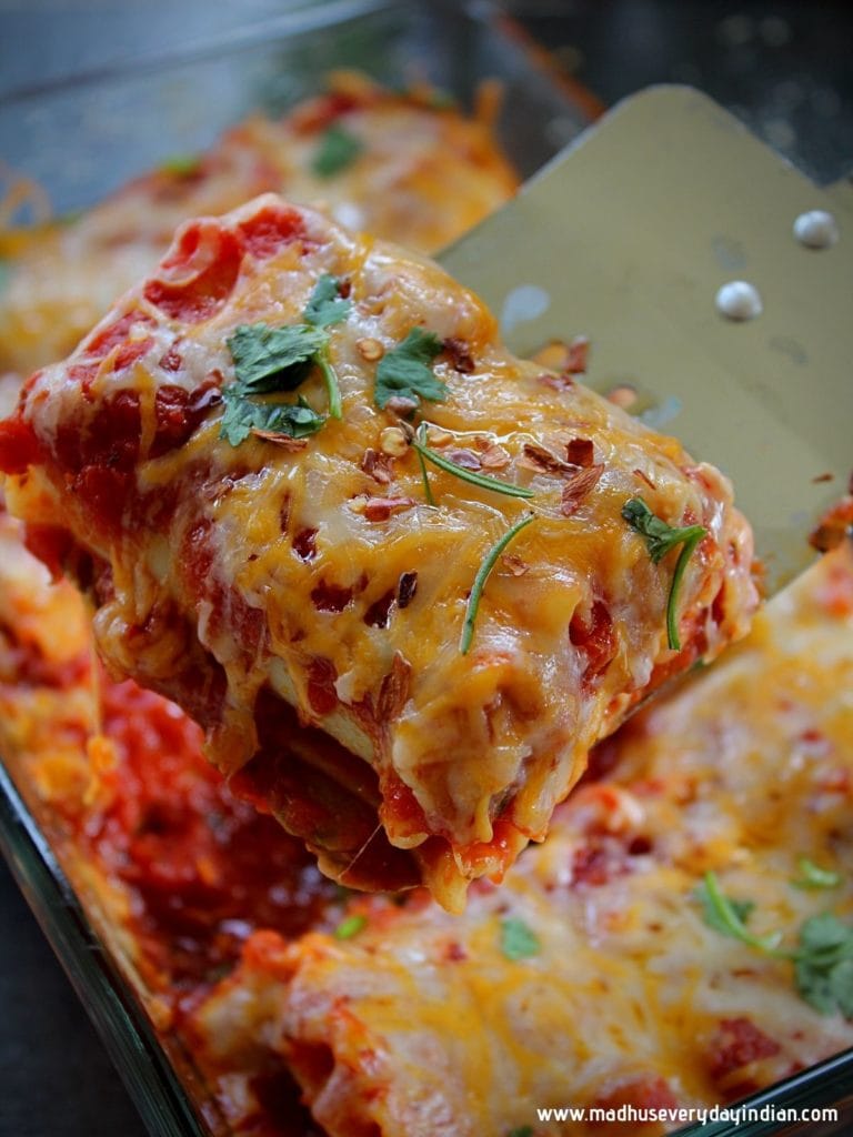 vegetable lasagna being picked up with a spatula from a tray