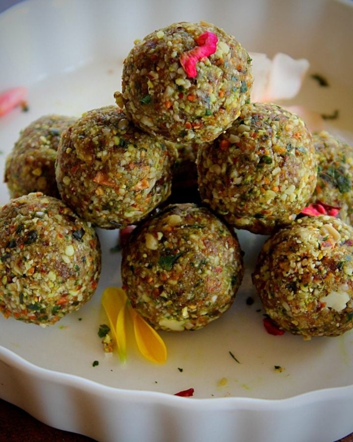 paan coconut nuts ladoo served in a white bowl garnished with rose petals