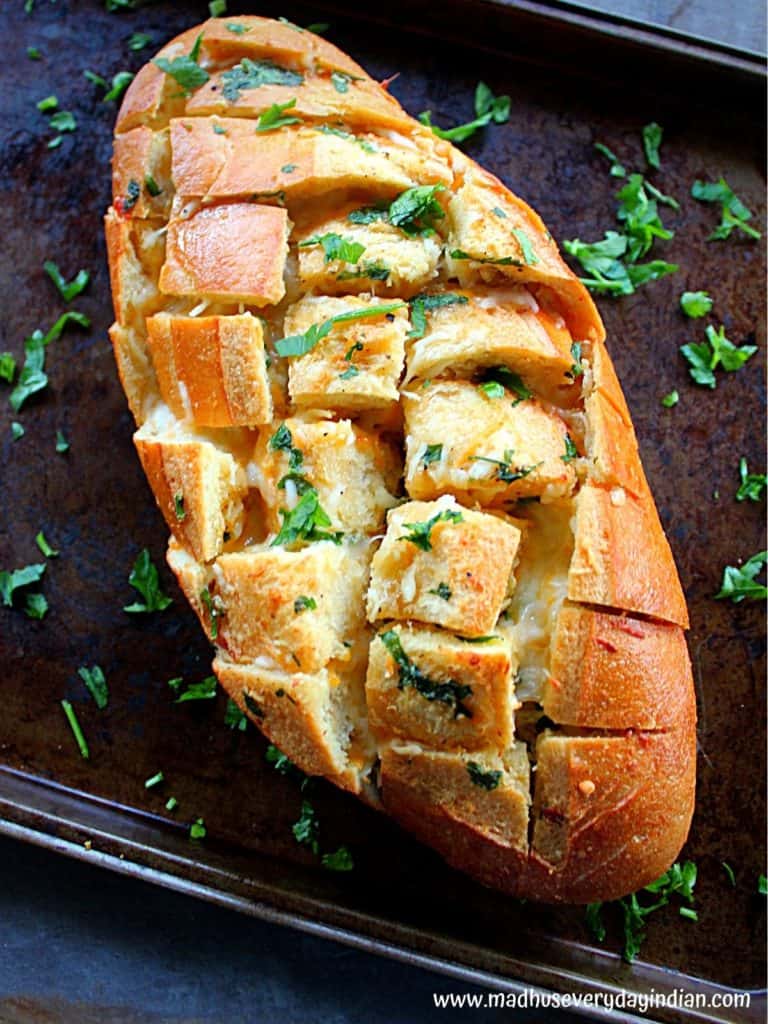 pull apart bread with garlic and cheese baked till crisp and served with chopped fresh pasrely