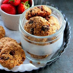 healthy breakfast cookies served in a glass jar with some strawberry