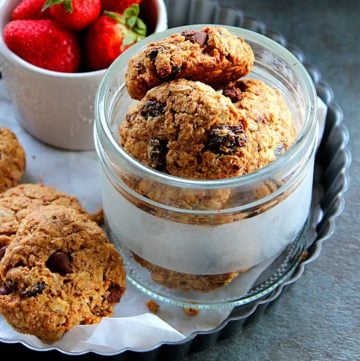 healthy breakfast cookies served in a glass jar with some strawberry