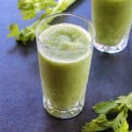 celery smoothie served in two glass cups with celery stalks