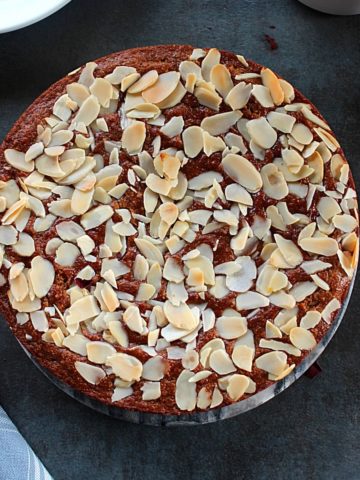 eggless almond cake topped with slivered almonds