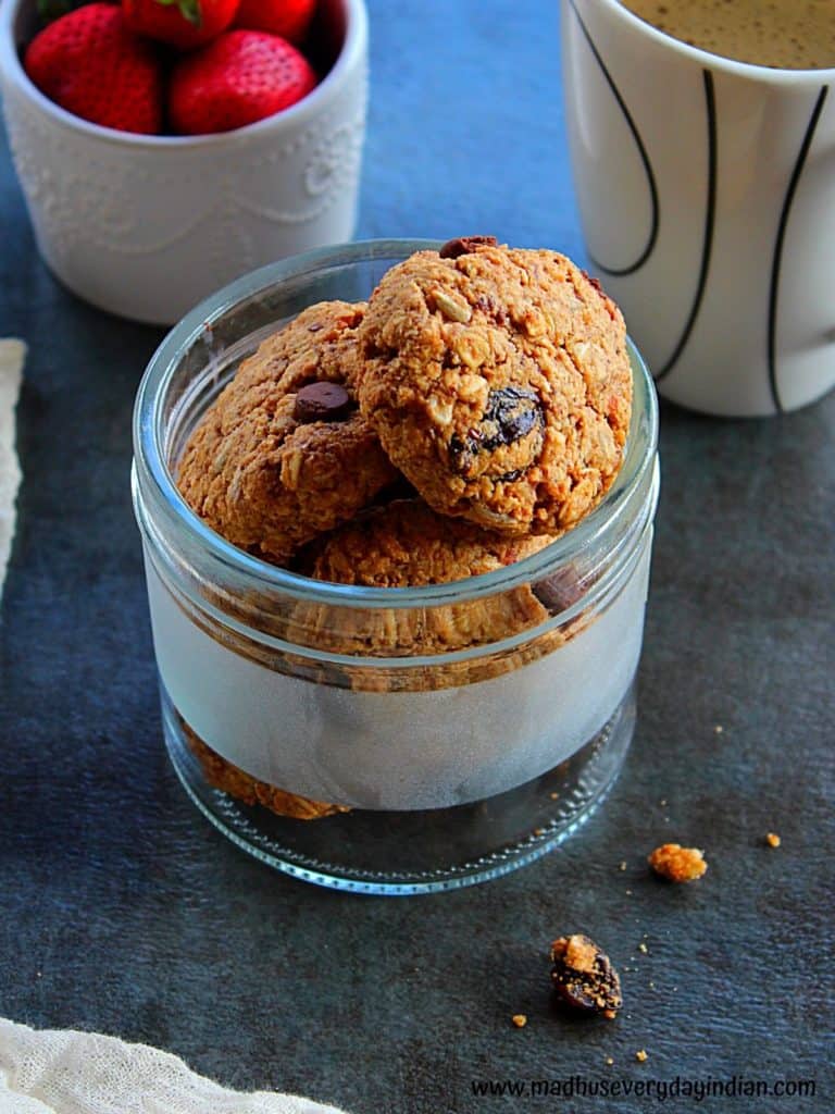 healthy breakfast cookies served in a glass jar with some strawberry and coffee