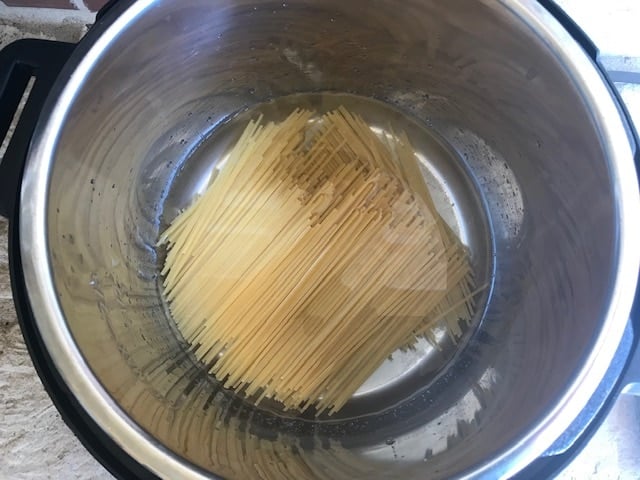 adding spaghetti to the insatnt pot