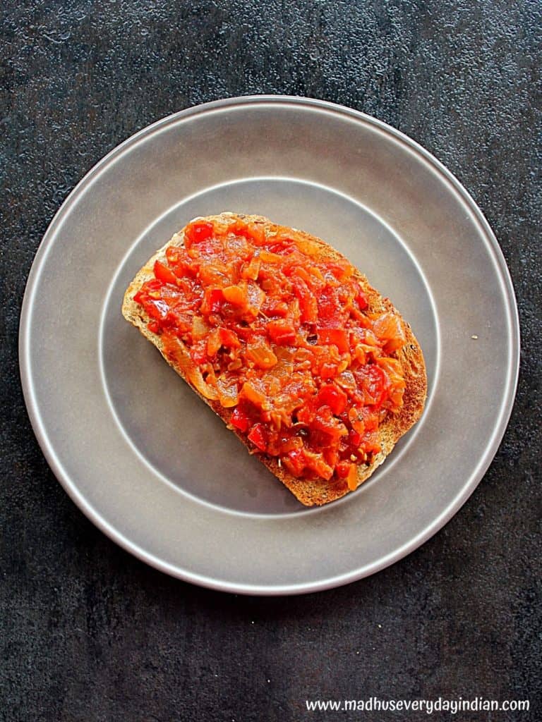 tomato chutney on a sour dough bread and served on a grey plate