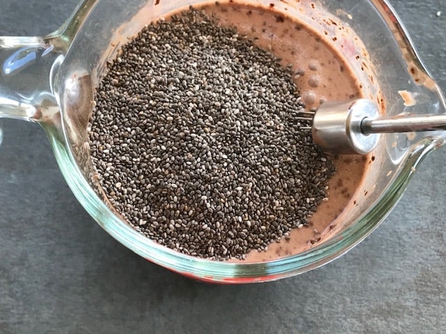 chia seeds added to coco powder and milk mixture