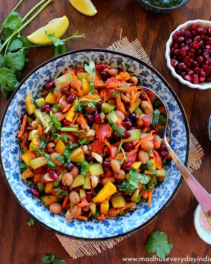 boiled peanut chaat served in a colorful bowl, with pomegranate and other chutneys.
