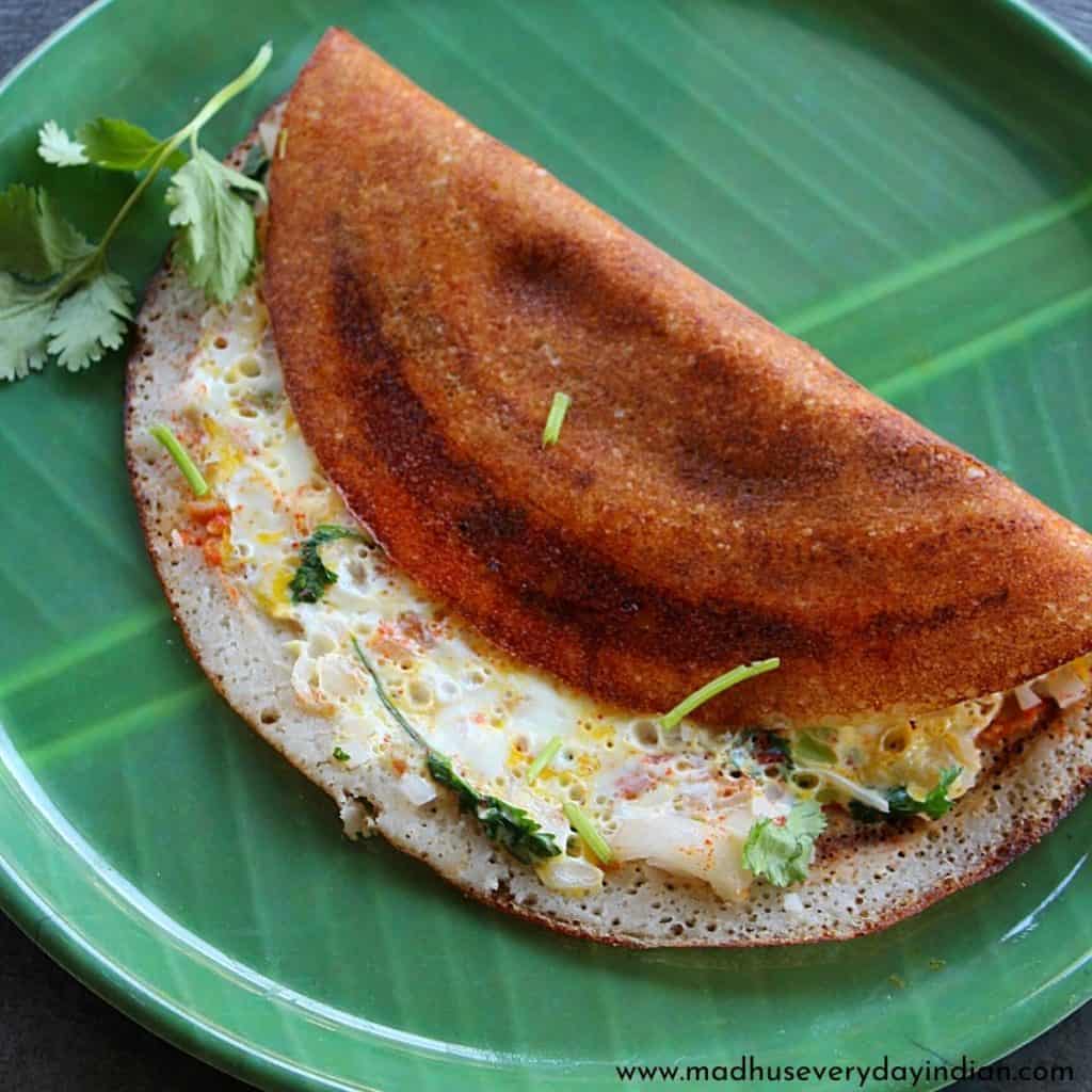 egg dosa garnished with coriander leaves