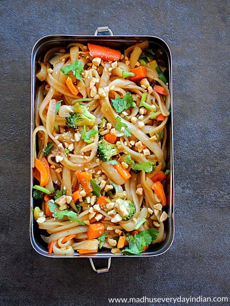 pad thai with veggies served in a steel lunch box