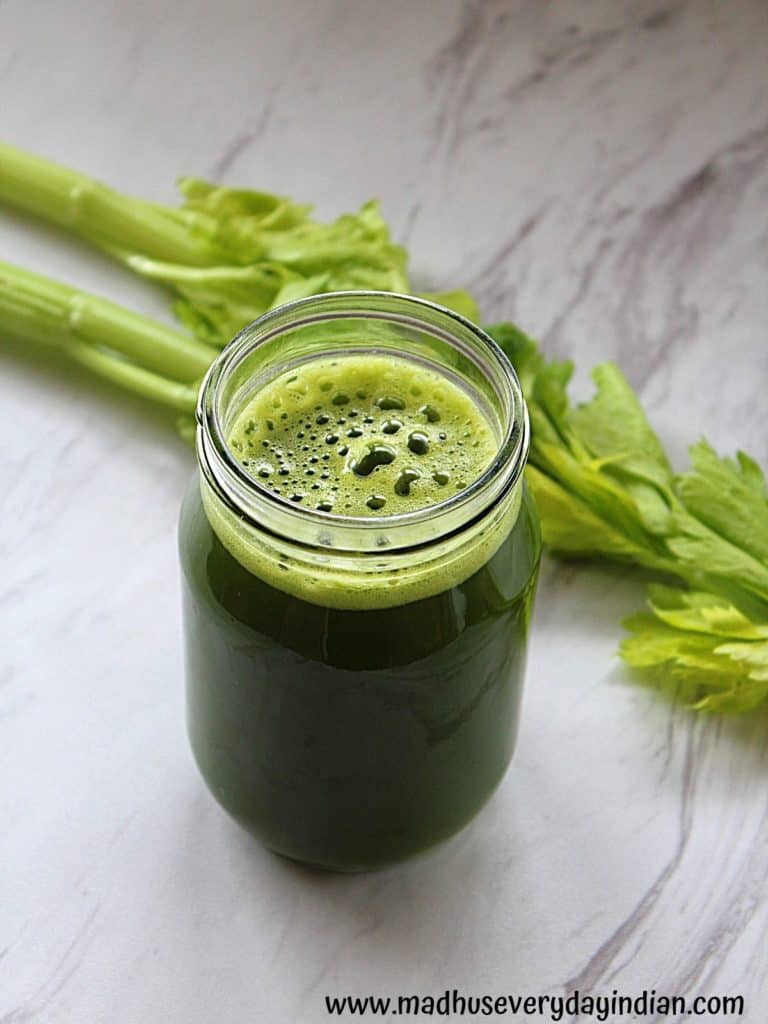 green juice served in a glass jar with celery on the side