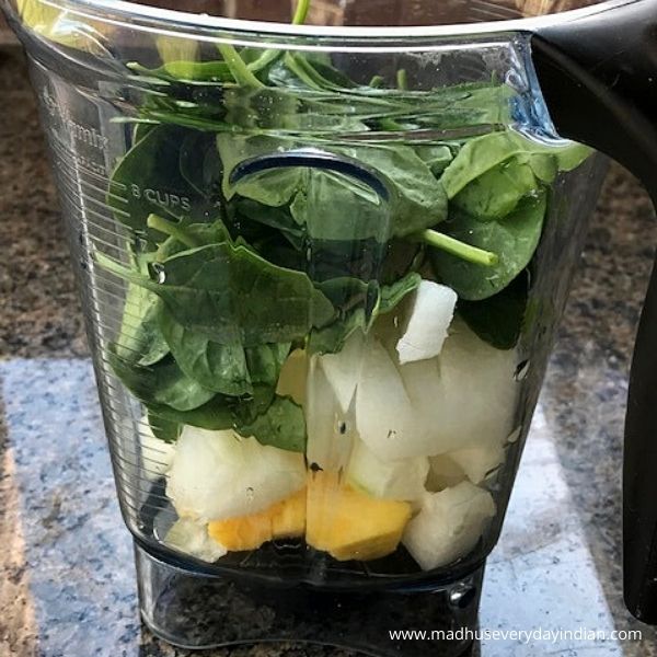 pineapple, ash gourd and spinach added in a blender