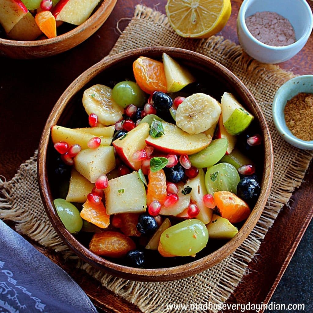 fruit chaat served in a wooden bowl