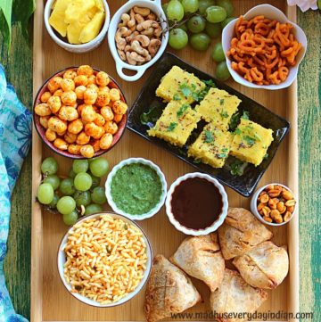 indian snack and chaat cuterie board with assorted appertizers in a board