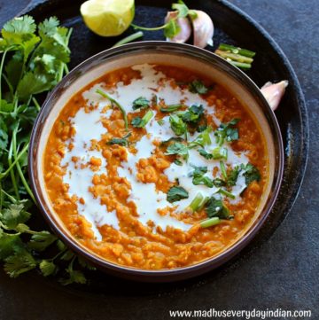 vegan red lentil curry served in a brown bowl