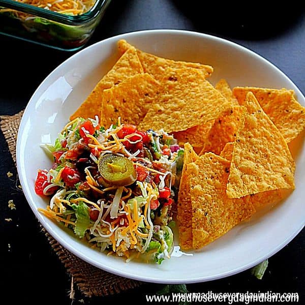 7 layer dip served with nacho chips