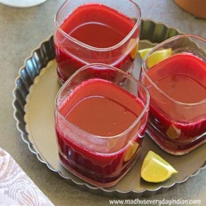 3 glasses of apple beet carrot juice served with lime wedges