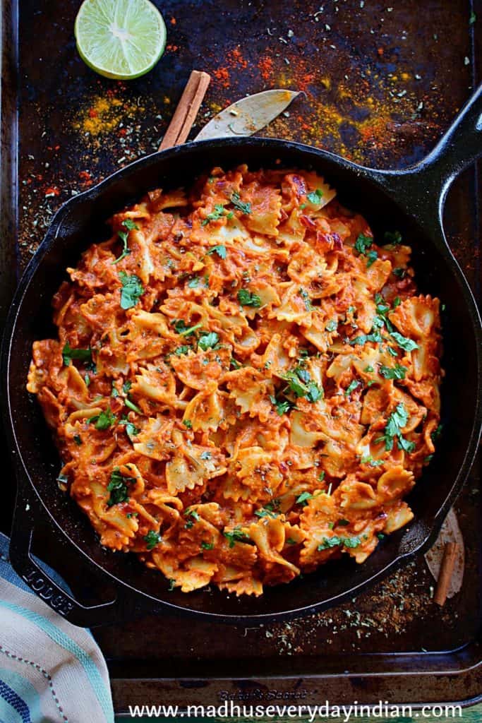 veg tikka masala pasta served in a cast iron skillet sprinkled with herbs