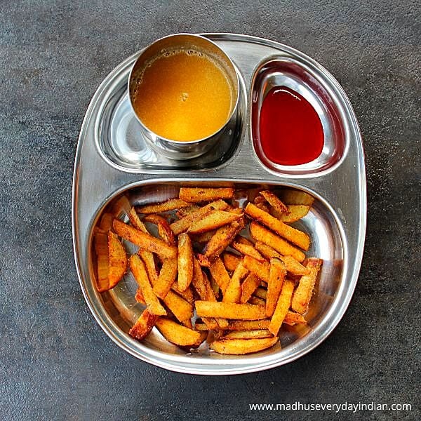 masala fries erved with chili sauce and juice