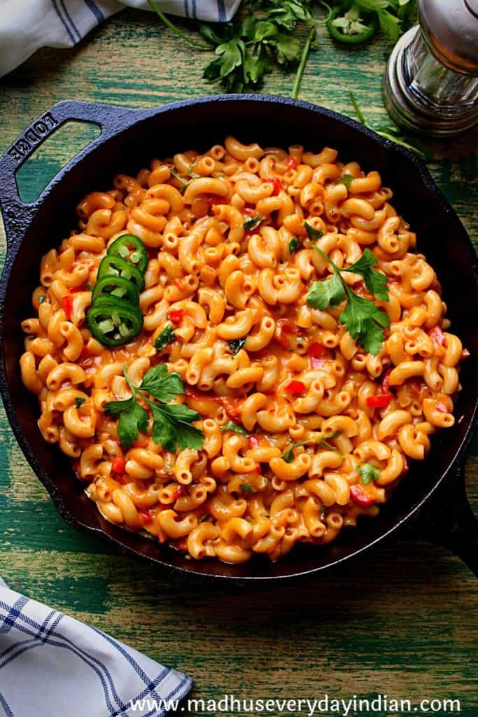 spicy mac and cheese served in a lodge cast iron pan
