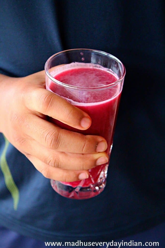 pomegranate juice held in a hand
