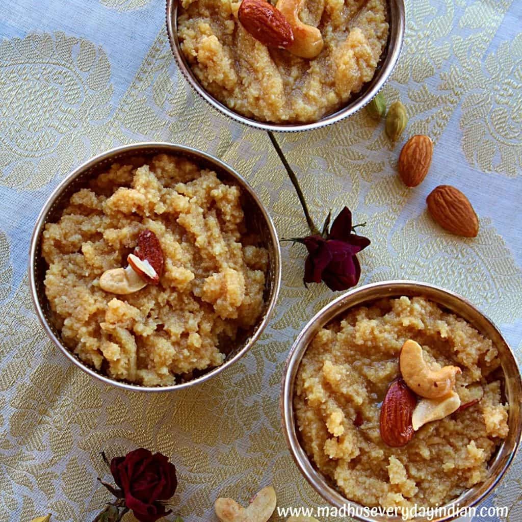 3 cups of khus khus halwa arranged in silver bowls garnished with nuts