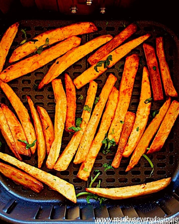 masala fries air fryer garnished with cilantro